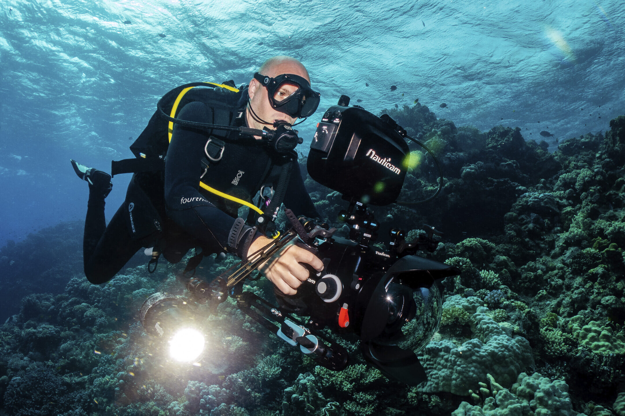 Underwater cinematographer filming on a reef