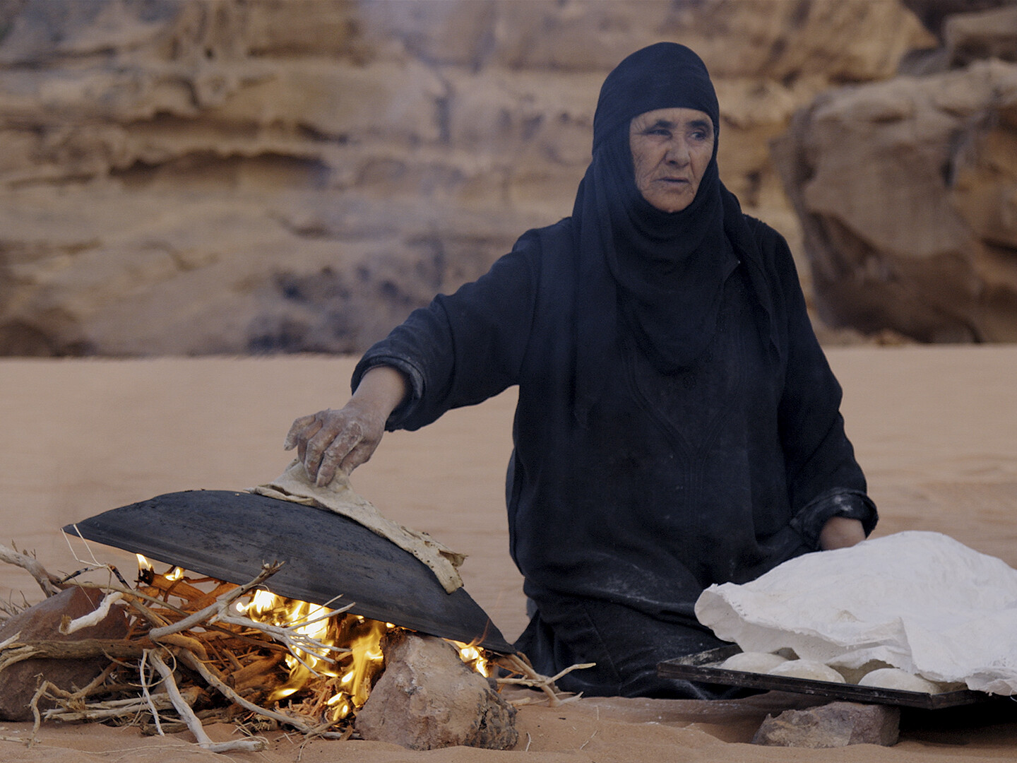 Woman making bread in the desert